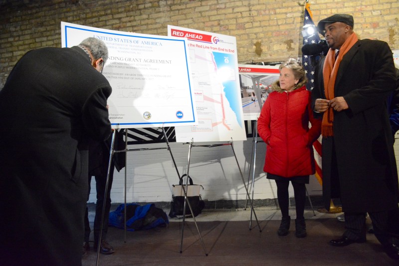 CTA president Dorval Carter signs a giant funding agreement at this morning's event. Photo: CTA