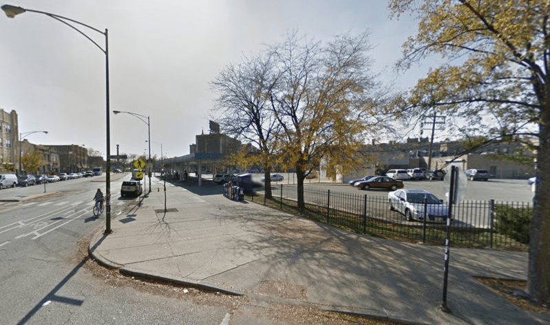 Community groups want to replace this parking lot next to the Logan stop with affordable housing. Image: Google Street View