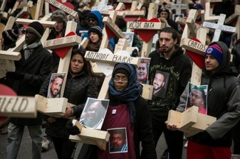 Loved ones and activists marched with crosses on Michigan Avenue Saturday to honor homicide victims. Photo: Ashlee Rezin, Sun-Times Media