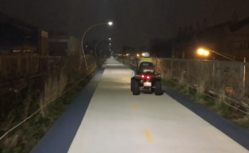The police ATVs take up half the width of the paved path. Image: Steven Vance