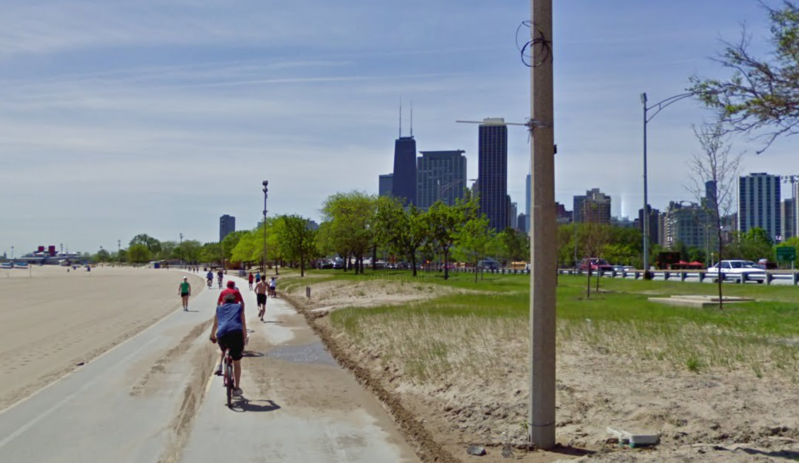 Under the plan, the existing mixed-use path between North and Fullerton will be designated for pedestrian use only, and a new paved bike-only route will be built in the grassy area to the right of this photo, close to Lake Shore Drive. Image: Google Street View