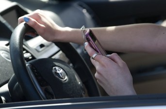 Photo of driver holding a cellphone