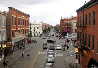 Most of the right-of-way at Milwaukee/North/Damen is used for moving private motor vehicles, so there's relatively little space for pedestrians, and no dedicated lanes for buses or bikes. Photo: Brandon Bartoszek