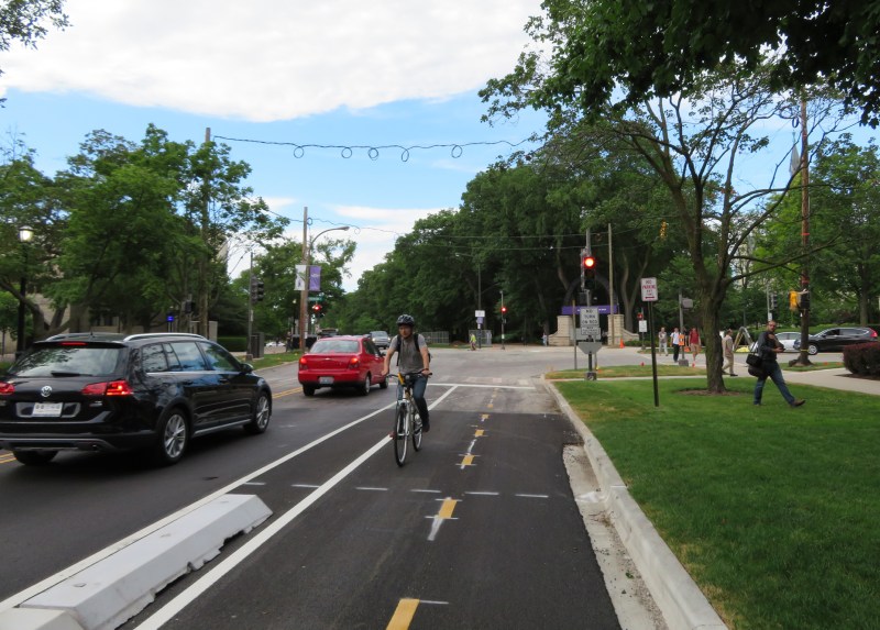 A cyclist enters the Chicago Avenue protected bike lane at the Sheridan Road curve. Photo: Jeff Zoline