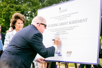 Maryland Governor Larry Hogan inks the deal on Maryland's long planned "Purple Line" light rail. Photo: Greater Greater Washington
