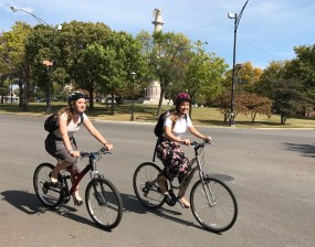 Amanda Aamodt and Emily McCrary ride by Logn Square's Illinois Centennial Monument. Photo: John Greenfield