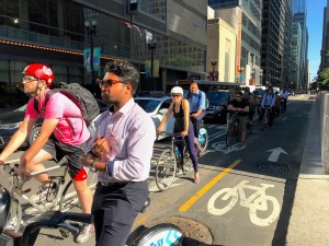Cyclists wait for a light in the Dearborn Street protected bike lane during the evening rush. Photo: John Greenfield