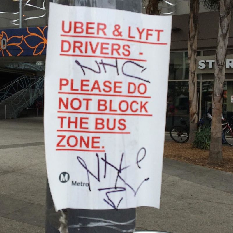 A sign, purporting to be posted by the L.A. Metro transit agency, says "Uber & Lyft Drivers - Please do not block the bus zone". Photo: Erik Griswold