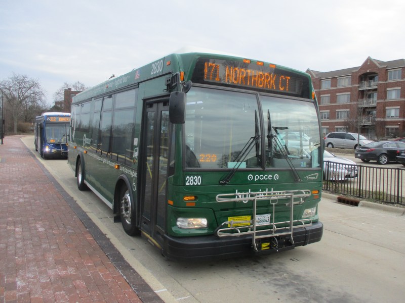 One of Pace's two diesel-electric hybrid buses waits to pick up passengers at Highland Park Metra station. Photo: Igor Studenkov