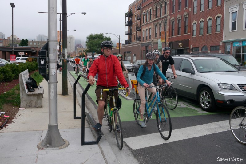 Looking south on Milwaukee from Ogden. The original "Curbee" bike footrest installed by Streetsblog's Steven Vance and friends was taken out by a motorist. Photo: Steven Vance
