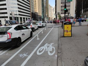 The new one-block stretch of bike lane on the east side Michigan between Washington and Randolph makes biking on the six-lane avenue a bit less intimidating. Photo: Twitter user @jimsey