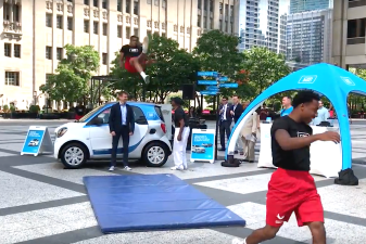 The Jesse White Tumblers lept over Car2Go CEO Olivier Reppert. Photo: John Greenfield