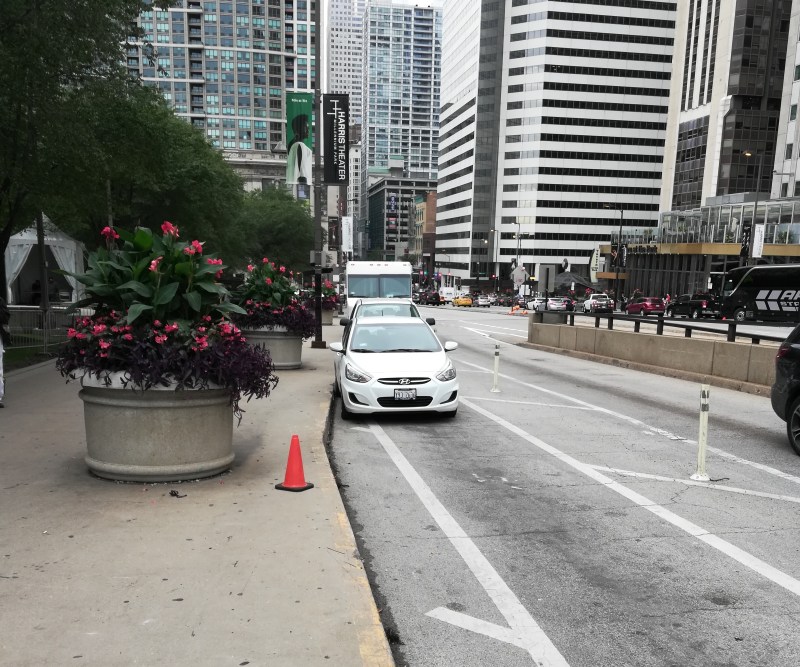 Looking west on Upper Randolph, a line of vehicles parked in the curbside bike lane by Millennium Park. Most photos in this post were taken last Friday by a Streetsblog reader who asked to be anonymous