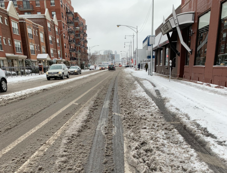 Main street travel lanes were plowed soon after the snowstorm ended, bikeways not so much. Photo: Halsted Bike Lane
