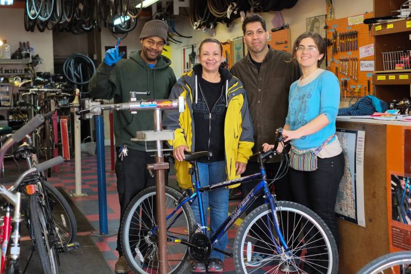 Staff from The Recyclery help set up a Rogers Park resident with a refurbished bike. Photo: Facebook
