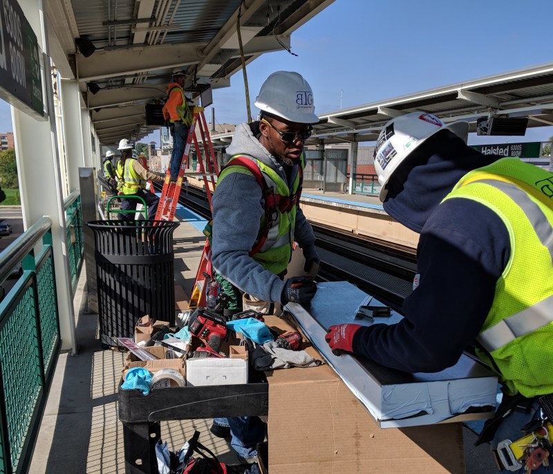 Contractors upgrade the lighting at the Halsted Green Line station. Photo: CTA