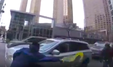 The passenger of a car that was blocking the Canal Street bike lane throws a liquid at a cyclist who photographed the vehicle. Image via Bike Lane Uprising and The Chainlink.