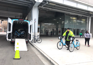 A worker collects  Divvy bikes for redistribution to empty stations at the Wilson 'L' stop this morning. Photo: John Greenfield