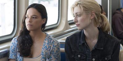 Michelle Rodriguez and Elizabeth Debicki ride the 'L' in "Widows."