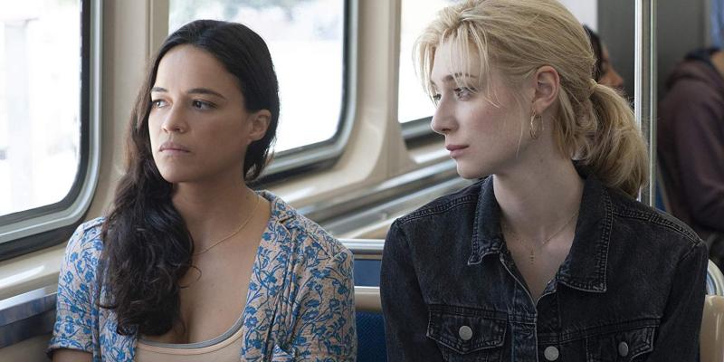 Michelle Rodriguez and Elizabeth Debicki ride the 'L' in "Widows."
