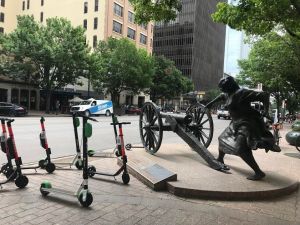 Scooters by the statue of Angelina Eberly, who prevented the theft of the Texas archives from Austin in 1842 by firing a cannon at the thieves. Photo: Lynda Lopez