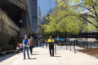 A security guard patrols the eastern section of the Chicago Riverwalk. It's still legal to bike on the riverwalk, but guards are ordering cyclists to dismount. Image: John Greenfield