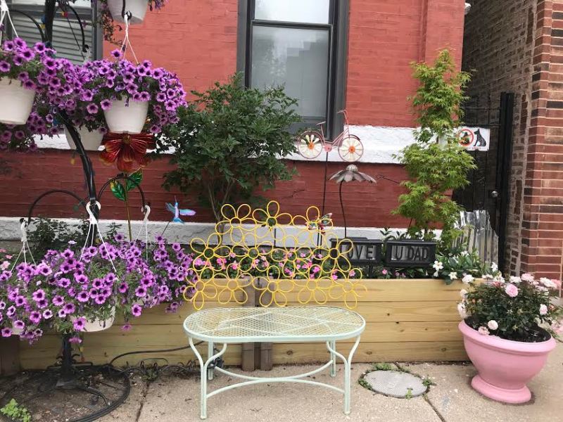 A bench and flowers placed in front of a house in Pilsen. Photo: Lynda Lopez