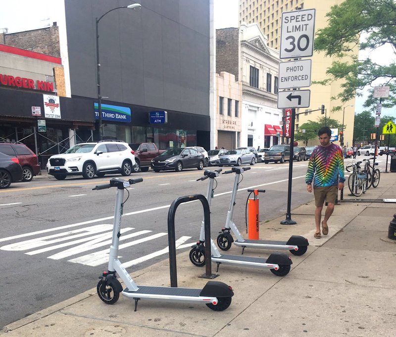 A photo of orderly scooter parking posted by the new pro-scooter (and tie-die-friendly) Twitter feed Chicago Scooters Are Fine.