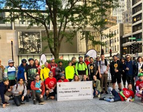 Cyclists pose with a giant check representing the $50 million a year the Illinois Legislature recently earmarked for walking and biking, at the urging of Active Trans. Photo: ATA