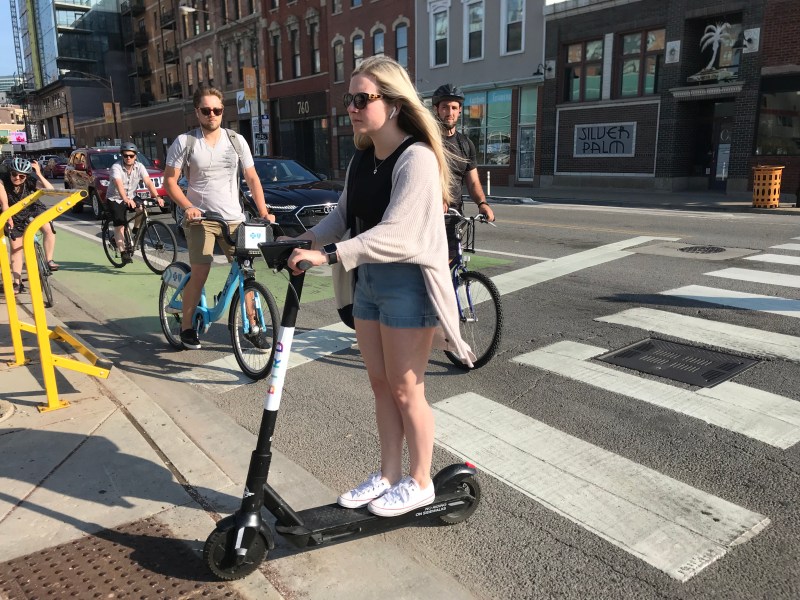 A scooter user rides on the sidewalk in River West. Photo: John Greenfield