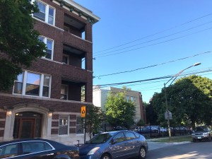 While a flier circulated by a neighbor called the development proposed for this parking lot "supersized," half of the building would be only about three feet taller than this four-story building next door, and the other half would be considerably shorter. Photo: John Greenfield