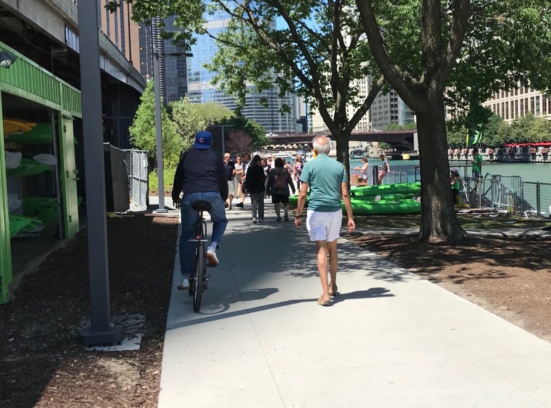 A man bikes (slowly) on the Chicago Riverwalk earlier this week. Photo: John Greenfield