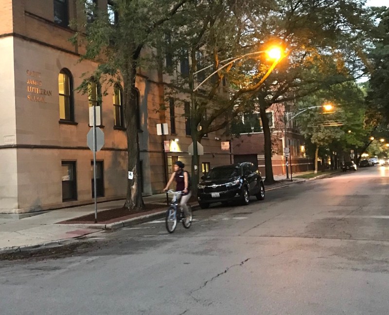 A cyclist rides past Saint James Lutheran School on Dickens Avenue in Lincoln Park. Photo: John Greenfield