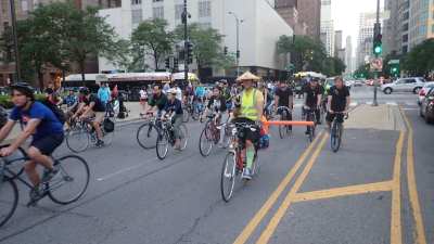 Critical Mass riders on Michigan Avenue during the "Safety Mass." The pool noodle is a reminder to drivers to give cyclists three feet of clearance when passing. Photo: Jerome Hughes