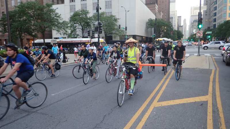 Critical Mass riders on Michigan Avenue during the "Safety Mass." The pool noodle is a reminder to drivers to give cyclists three feet of clearance when passing. Photo: Jerome Hughes
