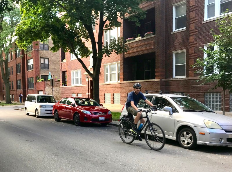 A cyclist rides on Leland Avenue near Artesian Street in Lincoln Square. Photo: John Greenfield