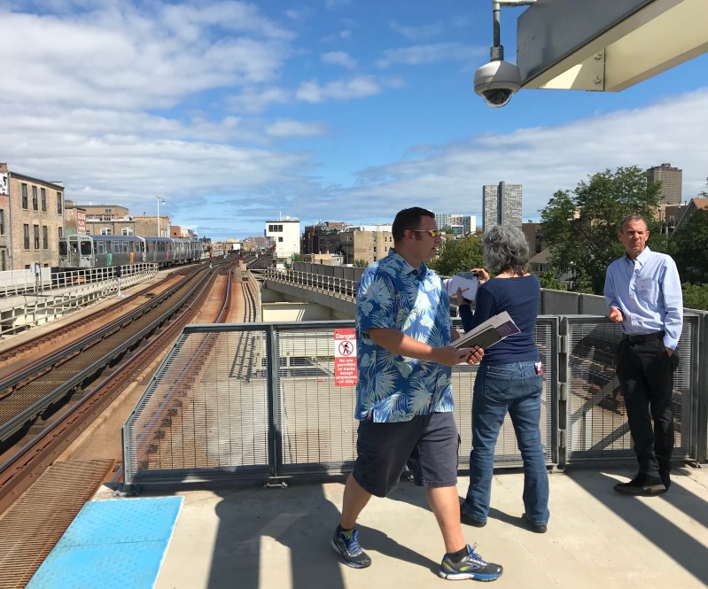Journalists check out the future site of the Belmont Flyover with CTA staffer Chris Bushell, right. The flyover will pass by the white control tower, with the tops of northbound Brown Line trains a bit higher than the top of the tower. Photo: John Greenfield