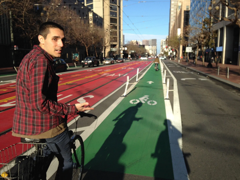 Former Streetsblog San Francisco editor Aaron Bialick rides on Market Street in 2015. Photo: John Greenfield