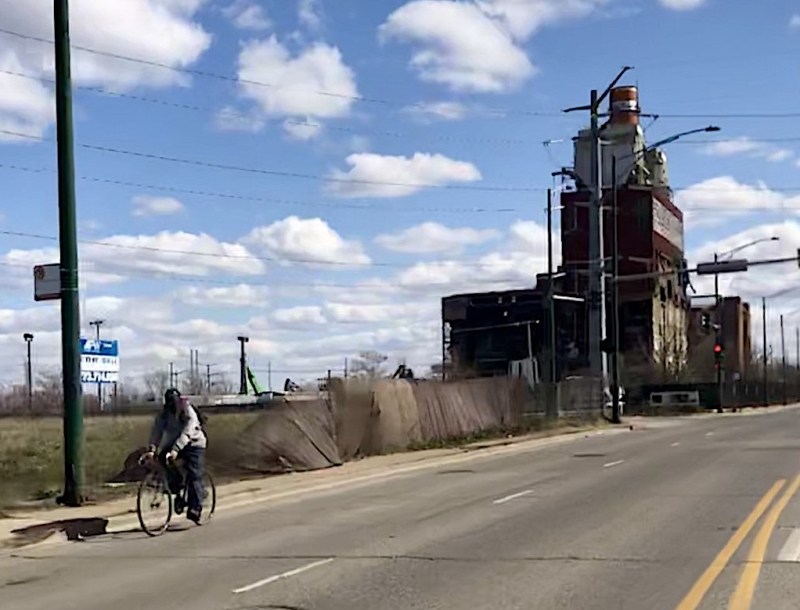 A person bikes by the Crawford power plant site. Photo: Mia Park