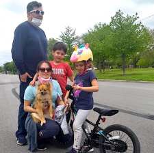 Santiago took advantage of the car-free drive this morning to teach his daughter Amelia how to ride a bike, while his son José cruised around in circles. Their mother Pamela and dog Chiple also joined in on the fun.  Photo: Michael Burton