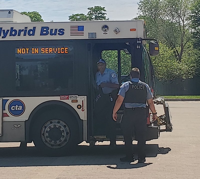 Police officers used the Humboldt Park Boathouse parking lot as a staging area during protests on Sunday. Officers with no face masks were seen entering and exiting a bus staffed by a CTA operator. Photo: Alyssa Iovinelli