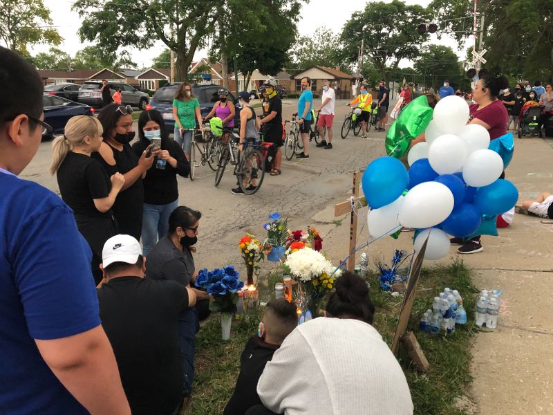 Mourning family members and friends of Isaac Martinez were joined by cyclists who formed a "human-protected bike lane" to honor him. Photo: Mia Park
