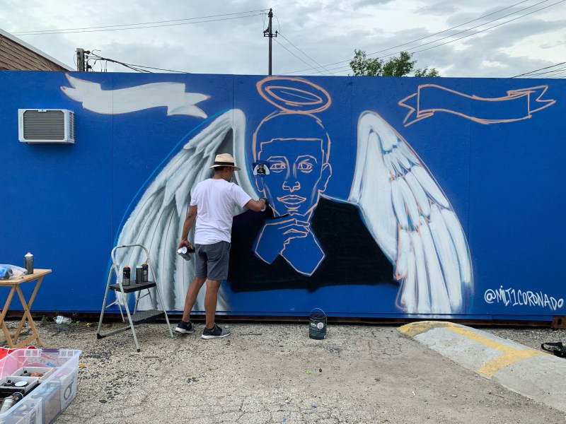 Artist Milt Coronado working on the mural. Photo: Kyle Lucas
