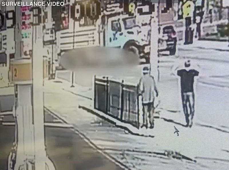 Still from security footage showing the CDOT trucker dragging the cyclist, who is blurred in the image.