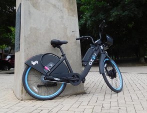 Electric Divvy against a monument