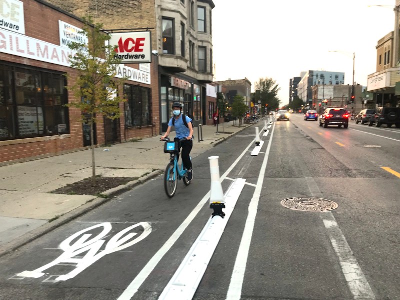 The new curb-protected bike lane on Milwaukee Avenue in Logan Square. Photo: John Greenfield