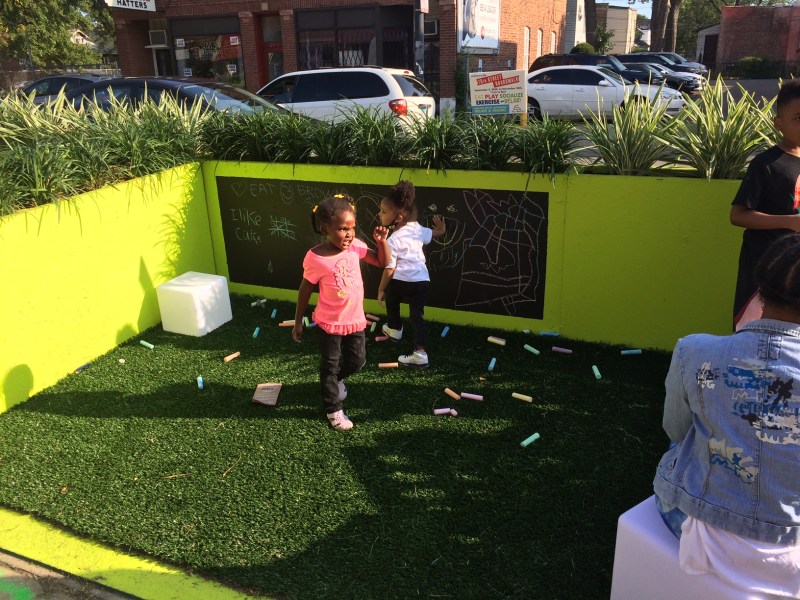 Kids wrote messages on a blackboard in one of the parklets. Photo: James Porter