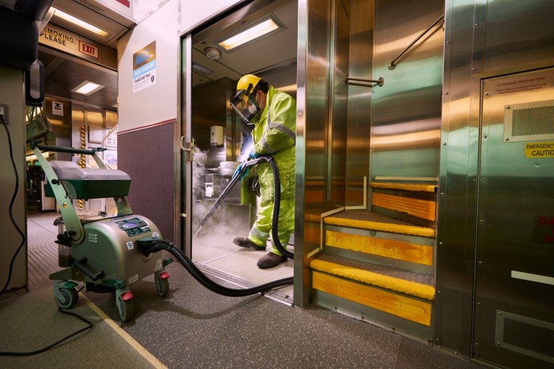A Metra worker uses "Ghostbusters"-like gear to sanitize an onboard restroom. Photo: Metra