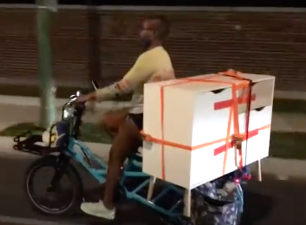 Courtney carries her new dresser past Graceland Cemetery on her cargo bike.