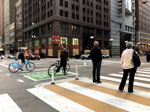 A paint-and-post pedestrian island in the east leg of Washington/LaSalle, by City Hall. Photo: CDOT